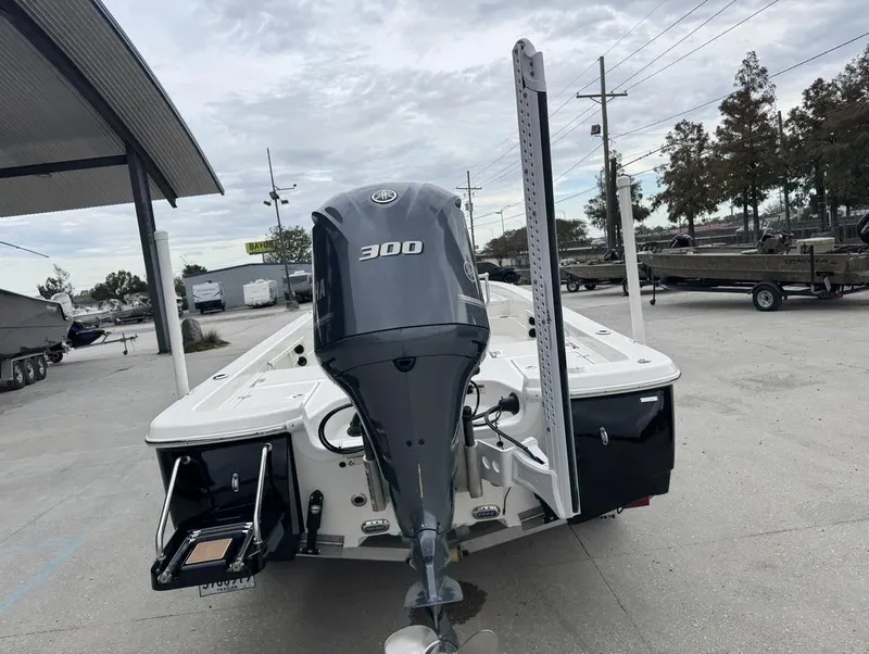 Slide: The Image of 2019 NauticStar 244 XTS boat with powerful 300 HP engine, parked outdoors. - 16