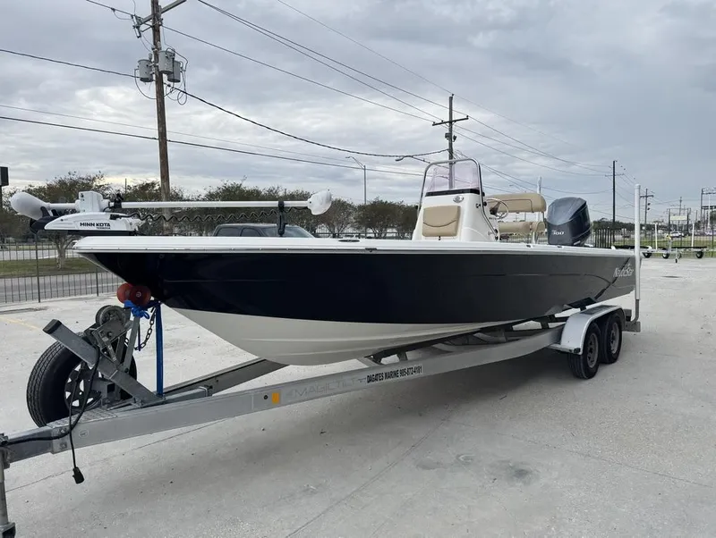 Slide: The Image of 2019 NauticStar 244 XTS boat on trailer, parked outdoors. - 4