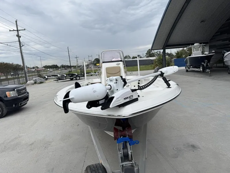 Slide: The Image of 2019 NauticStar 244 XTS boat with Minn Kota trolling motor in a marina setting. - 5