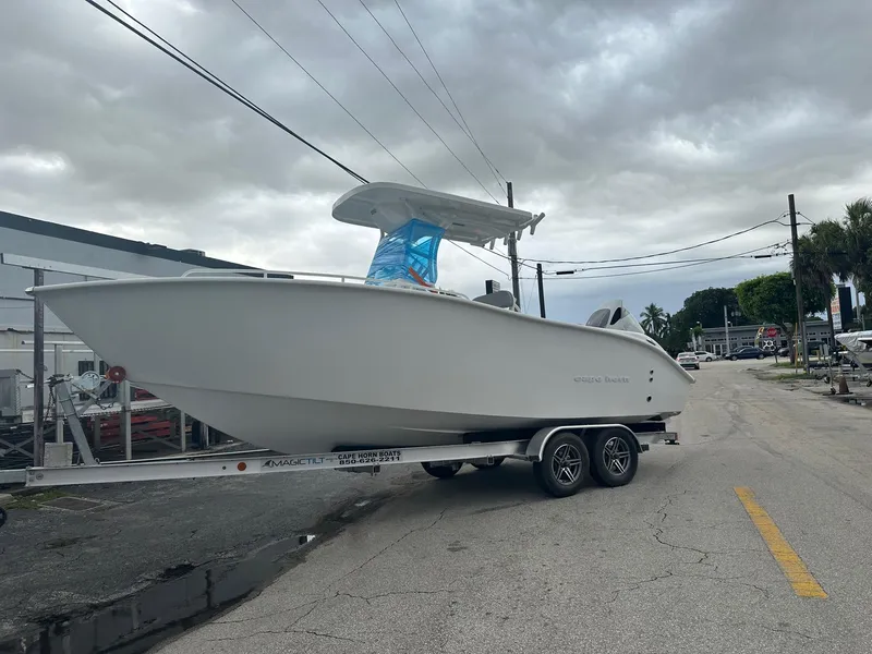 The Image of 2024 Cape Horn 22OS boat on trailer, parked on a street under cloudy skies. - 0