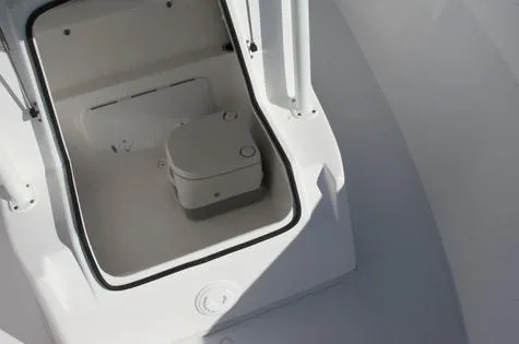 Slide: The Image of 2024 Cape Horn 22OS boat interior storage compartment with portable toilet. - 11