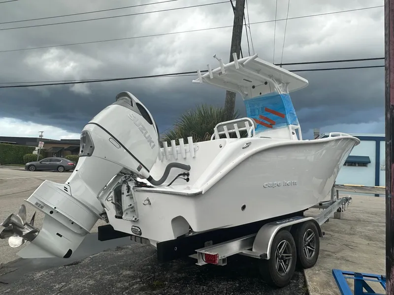 Slide: The Image of 2024 Cape Horn 22OS boat on trailer, overcast sky background. - 2