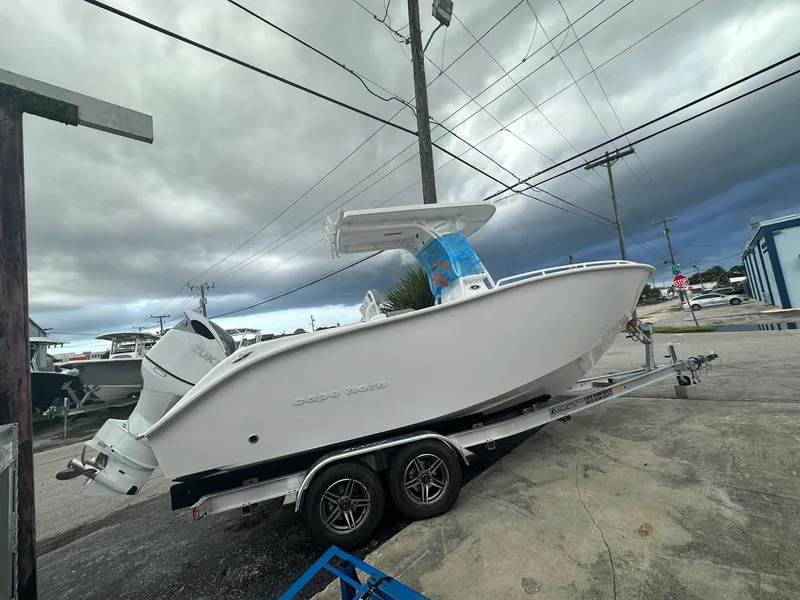Slide: The Image of 2024 Cape Horn 22OS boat on trailer under cloudy sky. - 4