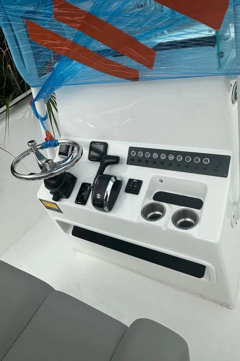 Slide: The Image of 2024 Cape Horn 22OS boat console with steering wheel and controls. - 7