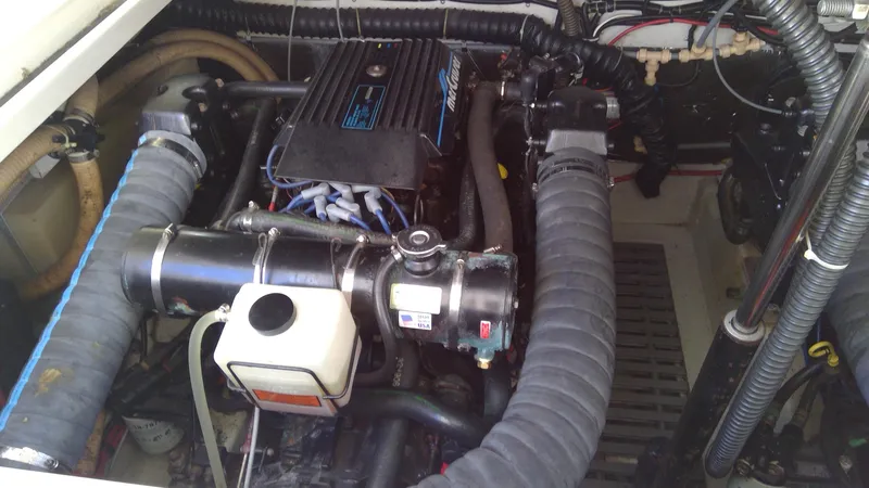 Slide: The Image of Engine compartment of a 1993 Tiara Yachts 3100 Open, showcasing mechanical components and hoses. - 14