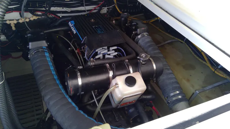 Slide: The Image of 1993 Tiara Yachts 3100 Open engine compartment with visible components and wiring. - 15