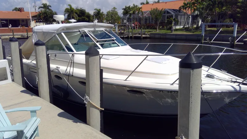 Slide: The Image of 1993 Tiara Yachts 3100 Open docked in a sunny marina. - 2