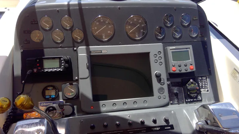 Slide: The Image of Dashboard of a 1993 Tiara Yachts 3100 Open with navigation and control instruments. - 25