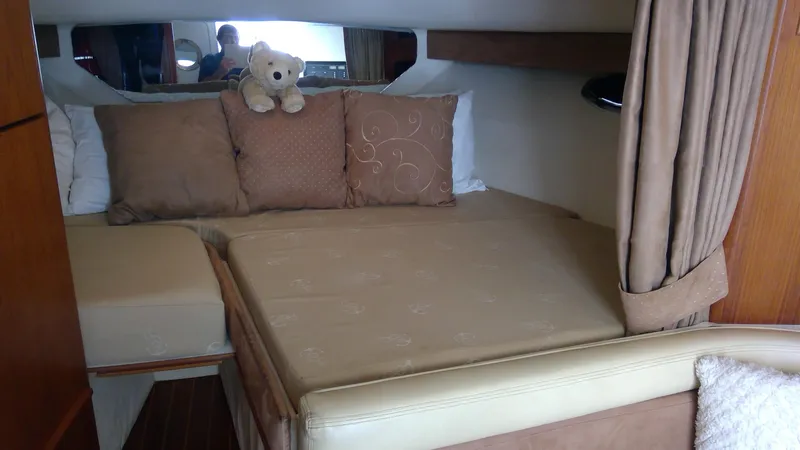 Slide: The Image of Cozy cabin interior of 1993 Tiara Yachts 3100 Open with plush bedding and teddy bear. - 29