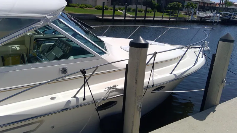 Slide: The Image of 1993 Tiara Yachts 3100 Open docked at marina, side view. - 3