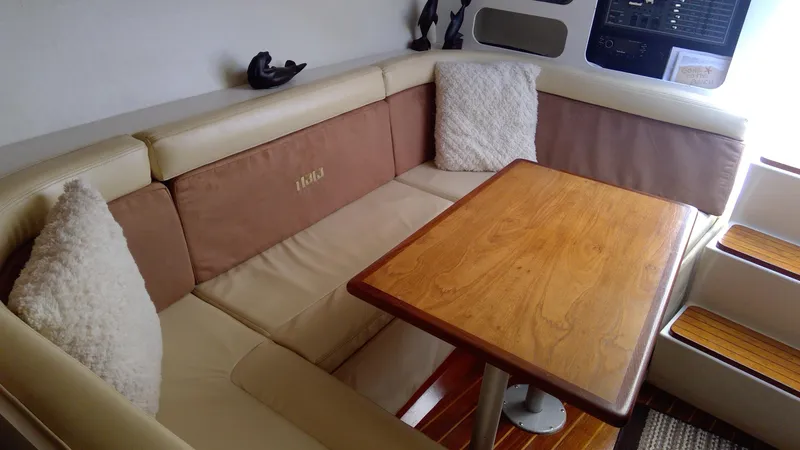 Slide: The Image of 1993 Tiara Yachts 3100 Open interior with cozy seating and wooden table. - 30