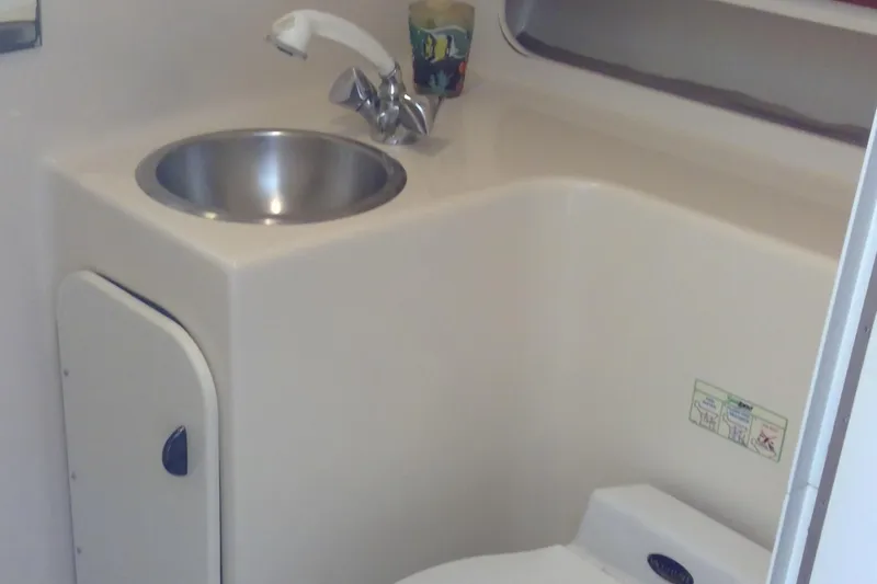 Slide: The Image of Compact bathroom in 1993 Tiara Yachts 3100 Open, featuring sink and faucet. - 35