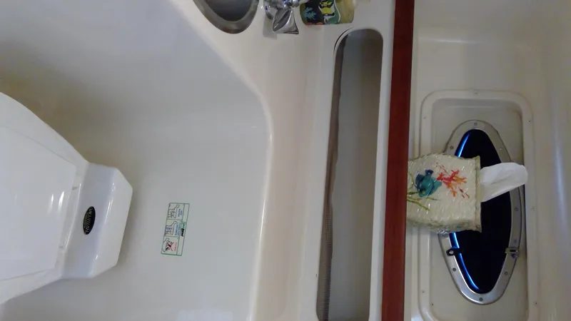 Slide: The Image of Interior of 1993 Tiara Yachts 3100 Open, featuring sink and porthole. - 37