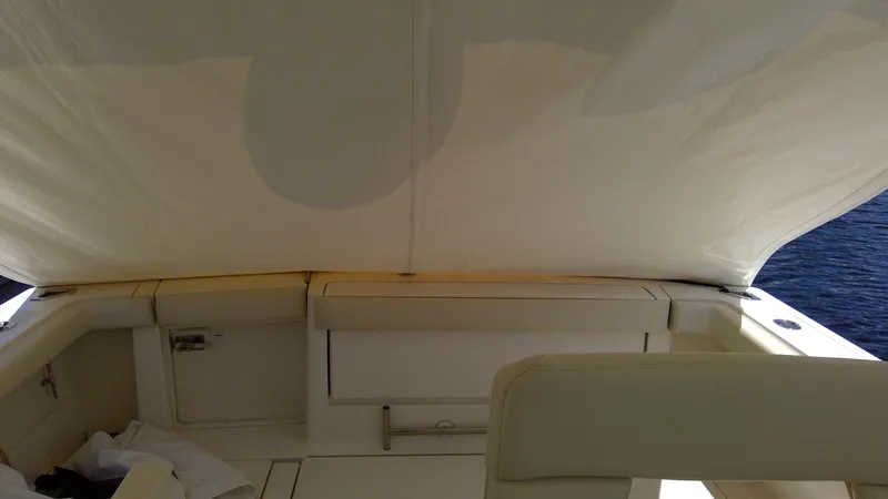Slide: The Image of 1993 Tiara Yachts 3100 Open interior with white seating and canopy. - 41