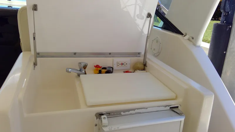 Slide: The Image of 1993 Tiara Yachts 3100 Open boat interior with sink and cutting board. - 43