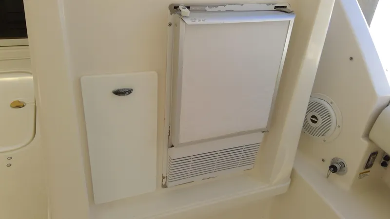 Slide: The Image of 1993 Tiara Yachts 3100 Open interior with built-in refrigerator and speaker. - 44