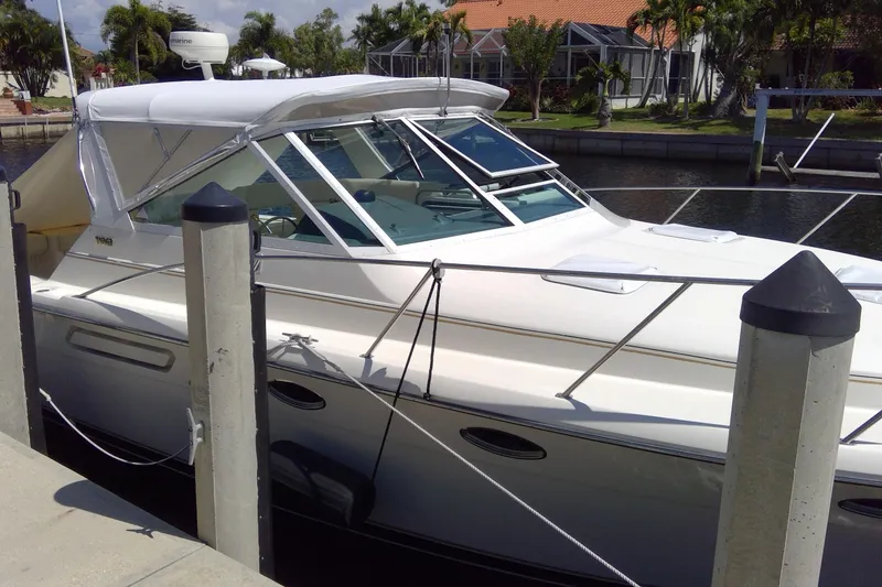 Slide: The Image of 1993 Tiara Yachts 3100 Open docked in a sunny marina. - 5