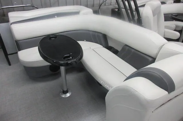 Slide: The Image of 2025 Sylvan Mirage 8520 Cruise boat interior with plush seating and a small table. - 2