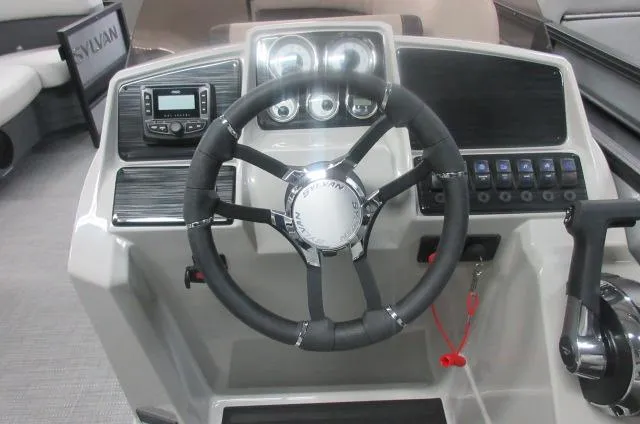 Slide: The Image of 2025 Sylvan Mirage 8520 Cruise boat dashboard with steering wheel and control panel. - 5
