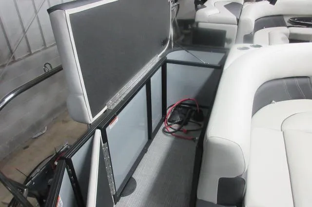 Slide: The Image of 2025 Sylvan Mirage 8520 Cruise interior with seating and storage area. - 6