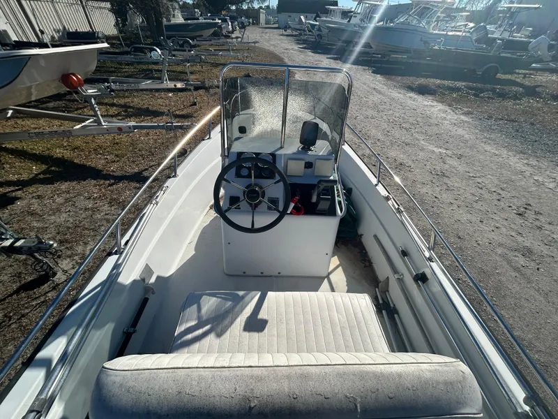 Slide: The Image of 1995 Boston Whaler Dauntless 15 boat interior with steering wheel and seating. - 4