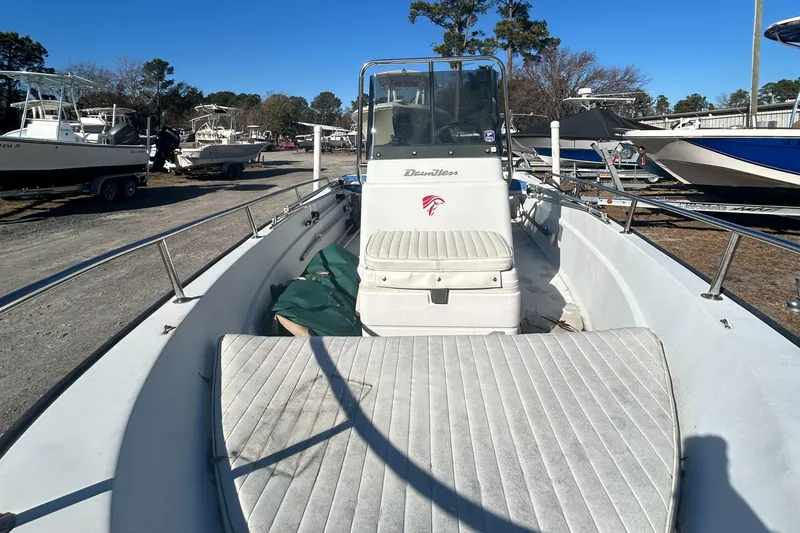 Slide: The Image of 1995 Boston Whaler Dauntless 15 boat, white interior, parked outdoors. - 6