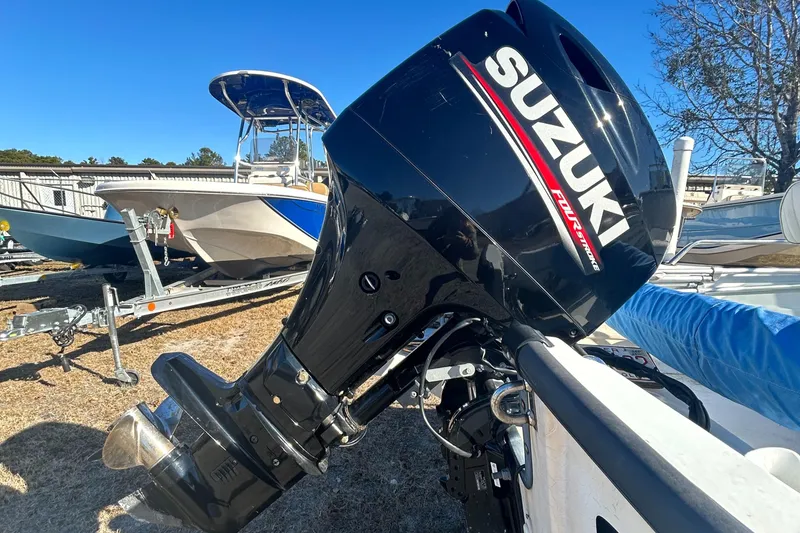 Slide: The Image of Suzuki outboard motor on 1995 Boston Whaler Dauntless 15 boat, parked on trailer. - 7