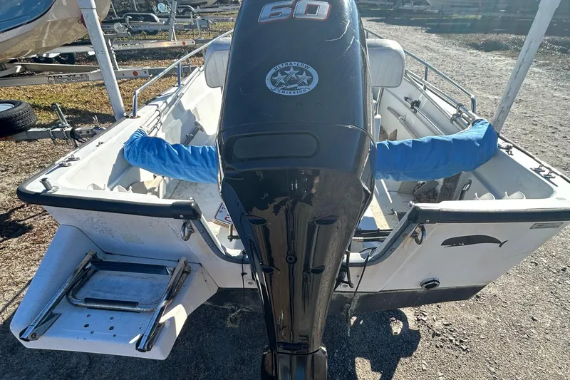 Slide: The Image of 1995 Boston Whaler Dauntless 15 with 60 HP outboard motor, rear view. - 8