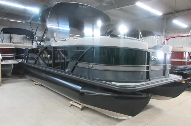 Slide: The Image of 2025 Sylvan L1 LZ pontoon boat in showroom, featuring sleek design and modern amenities. - 2