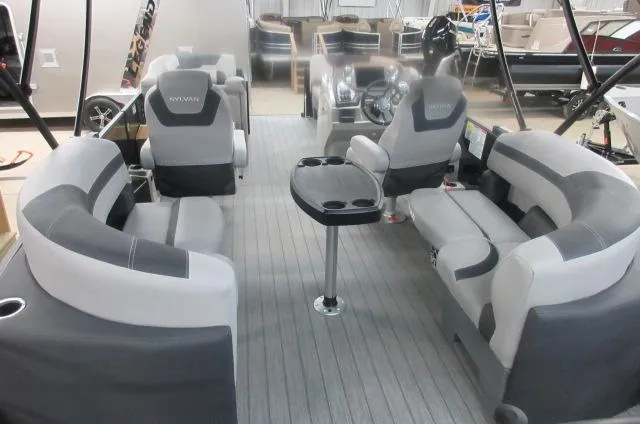 Slide: The Image of 2025 Sylvan L1 LZ pontoon boat interior with gray seating and central table. - 4