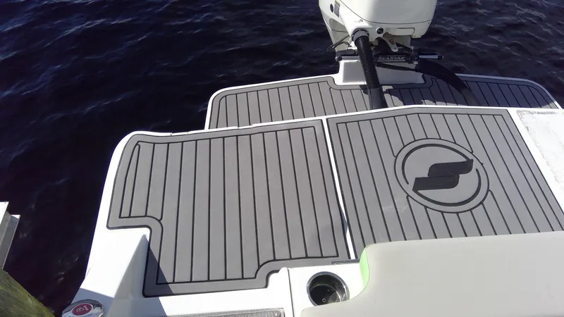 Slide: The Image of Starcraft SCX 240 boat deck, 2017 model, with gray non-slip surface near water. - 12