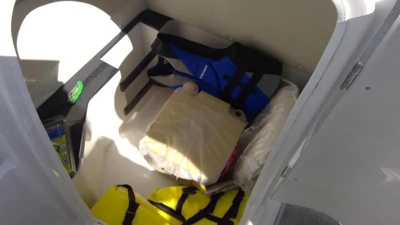 Slide: The Image of Storage compartment in 2017 Starcraft SCX 240 boat with life jackets and supplies. - 13