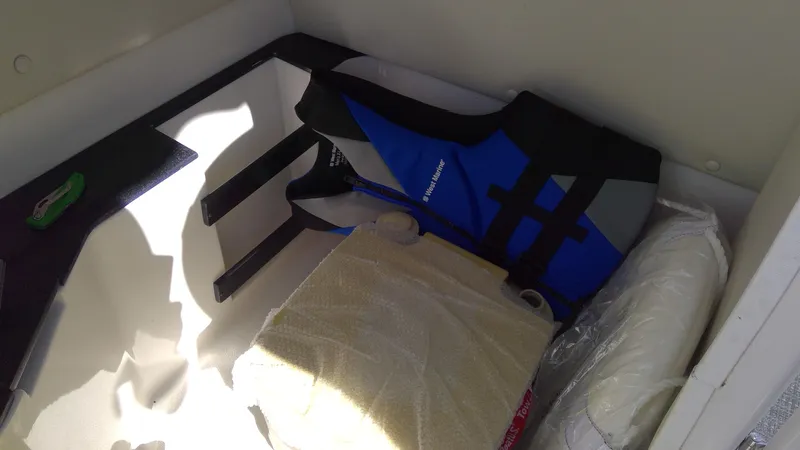 Slide: The Image of Blue life jacket in 2017 Starcraft SCX 240 boat storage compartment. - 15