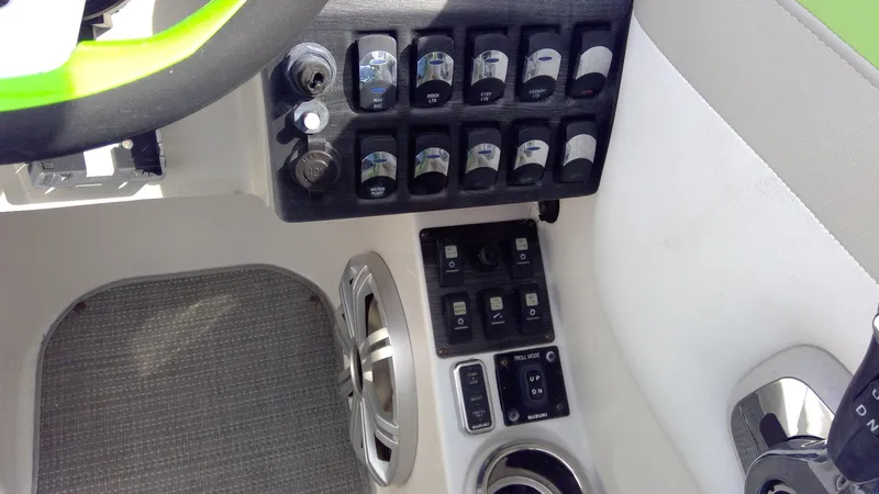 Slide: The Image of Control panel of 2017 Starcraft SCX 240 boat with switches and speaker. - 19