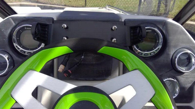 Slide: The Image of 2017 Starcraft SCX 240 dashboard with green steering wheel and dual gauges. - 20