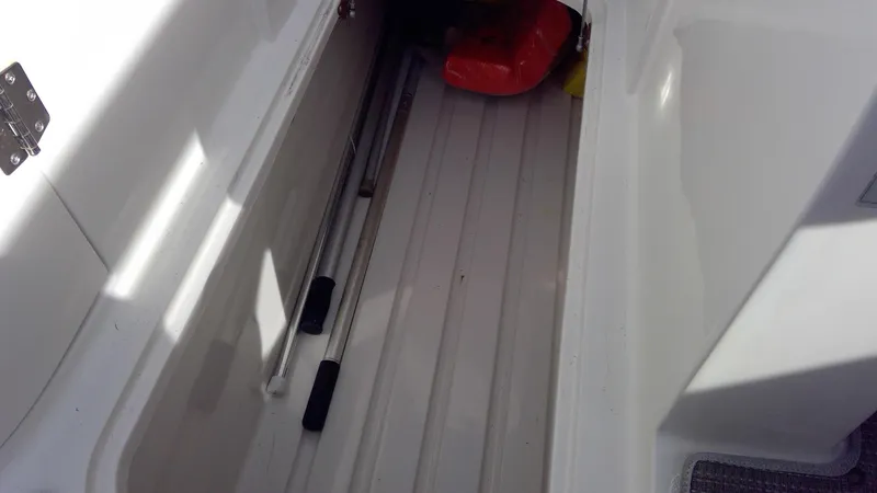 Slide: The Image of Storage compartment of 2017 Starcraft SCX 240 boat with safety equipment. - 21
