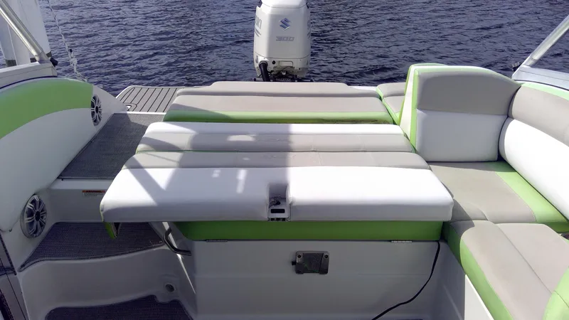 Slide: The Image of 2017 Starcraft SCX 240 boat with green and white seating, on calm water. - 24