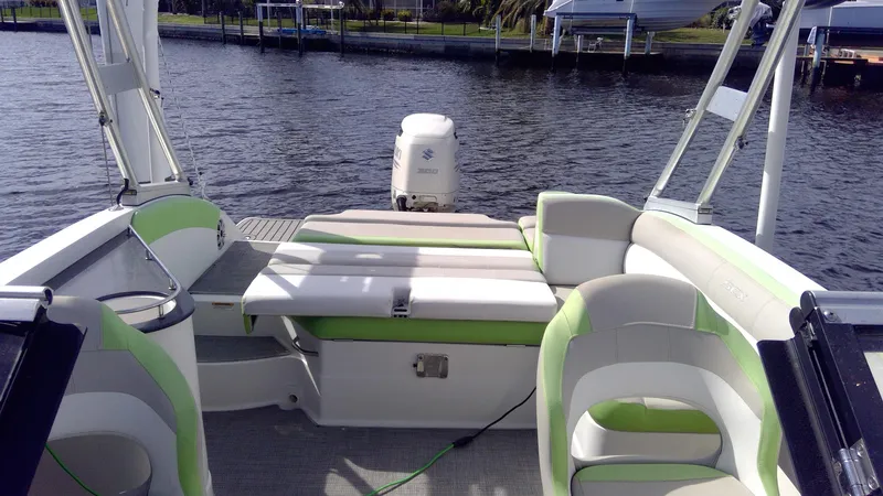 Slide: The Image of 2017 Starcraft SCX 240 boat interior with green accents on a calm lake. - 26