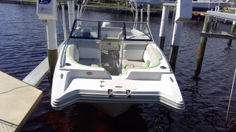 Slide: The Image of 2017 Starcraft SCX 240 boat docked on calm water, featuring spacious seating and sleek design. - 3