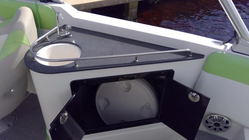 Slide: The Image of 2017 Starcraft SCX 240 boat interior with sink and storage compartment. - 30