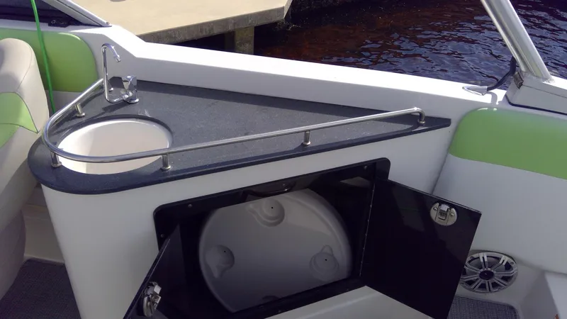 Slide: The Image of 2017 Starcraft SCX 240 boat interior with sink and storage compartment. - 31