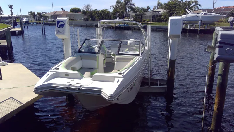 Slide: The Image of 2017 Starcraft SCX 240 boat docked on a lift in a sunny marina. - 4
