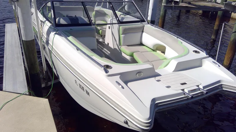 Slide: The Image of 2017 Starcraft SCX 240 boat docked, featuring white and green seating. - 5