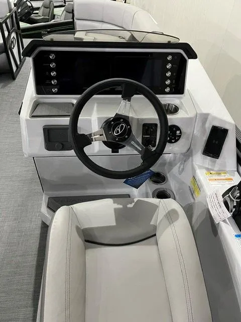 Slide: The Image of Steering console of 2025 Veranda VX 25 DCRC boat with modern controls and seating. - 13