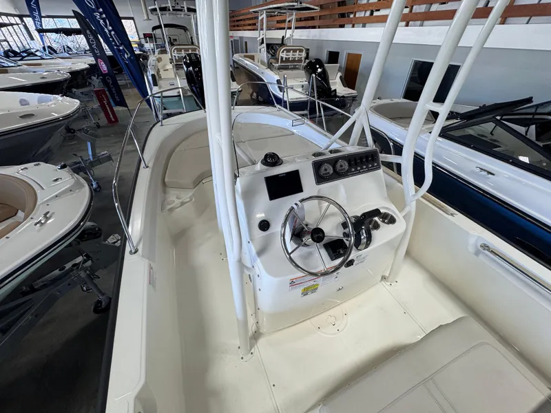 Slide: The Image of 2025 Boston Whaler 190 Montauk boat interior with steering console in showroom. - 4