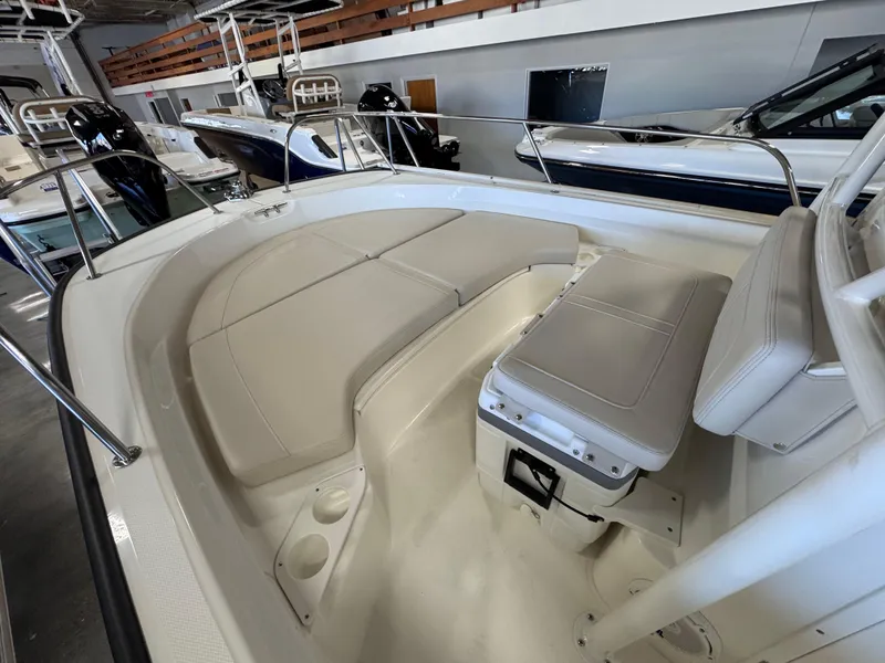 Slide: The Image of 2025 Boston Whaler 190 Montauk boat interior with cushioned seating and storage. - 5