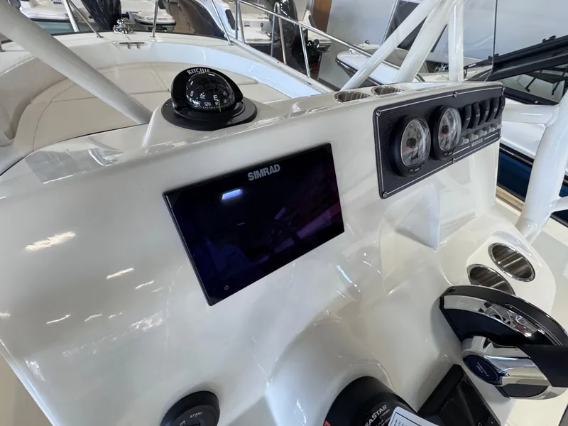 Slide: The Image of 2025 Boston Whaler 190 Montauk dashboard with Simrad display and gauges. - 6