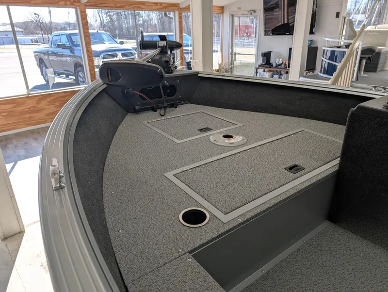 Slide: The Image of 2023 Starcraft Stealth 16 SC boat interior with storage compartments and fishing equipment. - 4