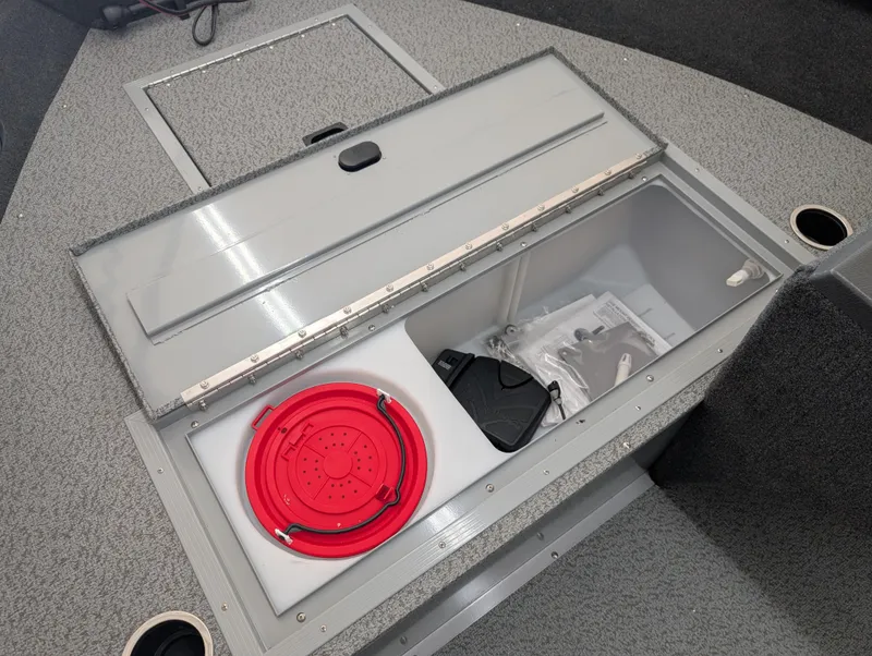 Slide: The Image of 2023 Starcraft Stealth 16 SC boat storage compartment with red bucket and accessories. - 7