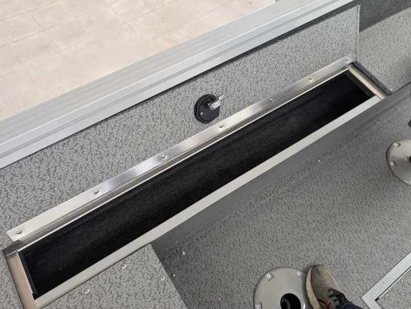 Slide: The Image of 2023 Starcraft Stealth 16 SC boat interior storage compartment with textured finish. - 8
